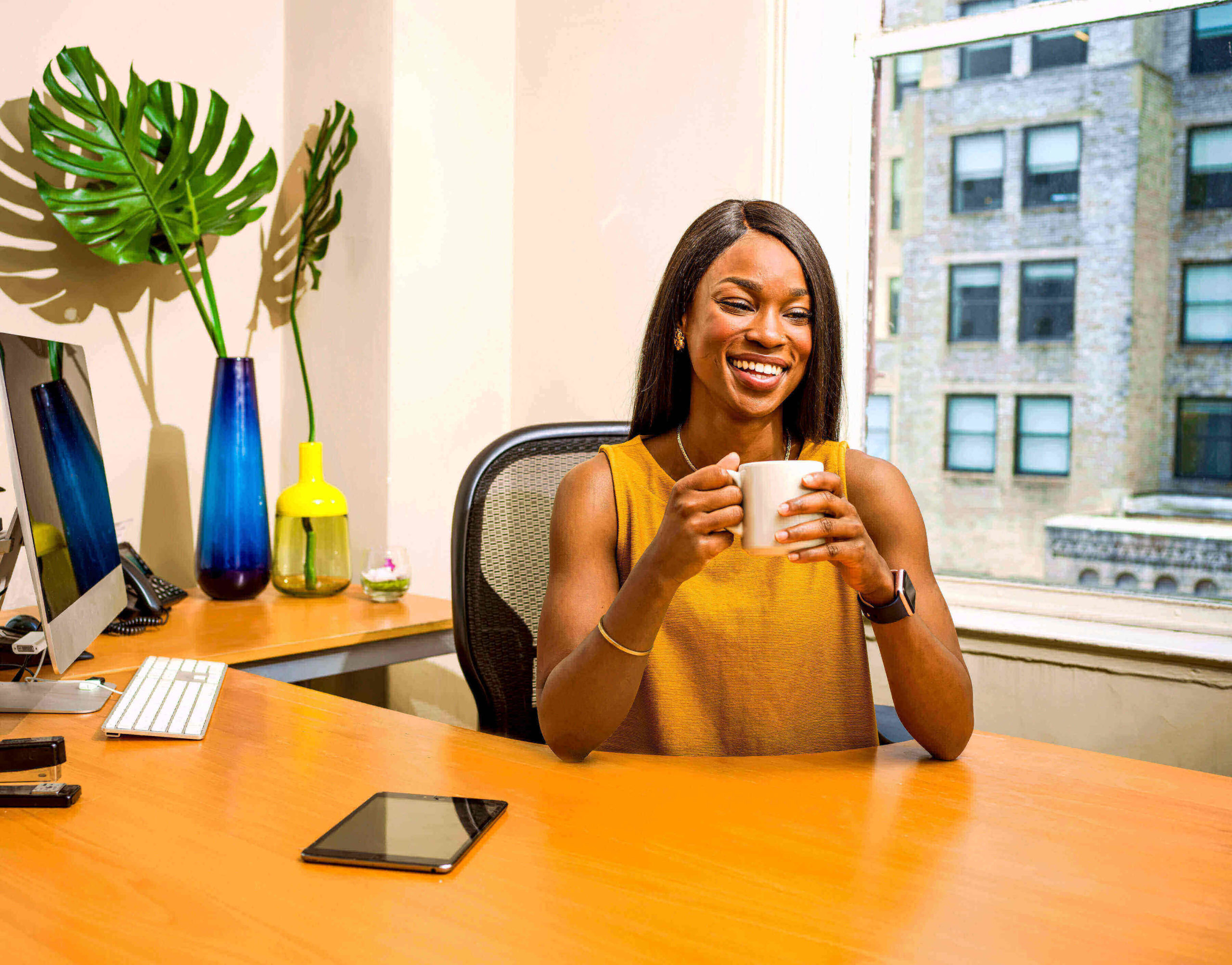 Woman sitting at an executive desk and smiling